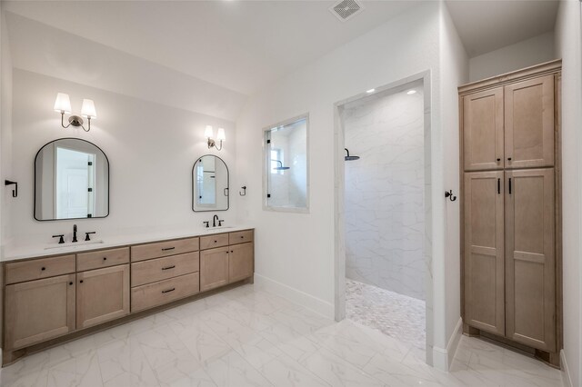 bathroom with vanity and tiled shower