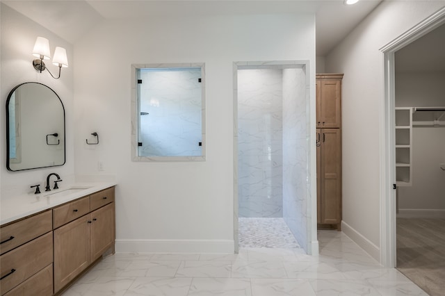 bathroom with tiled shower and vanity