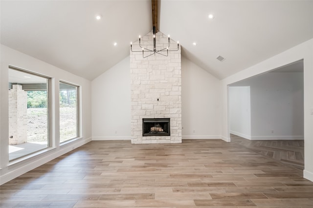 unfurnished living room with beam ceiling, high vaulted ceiling, and light hardwood / wood-style floors