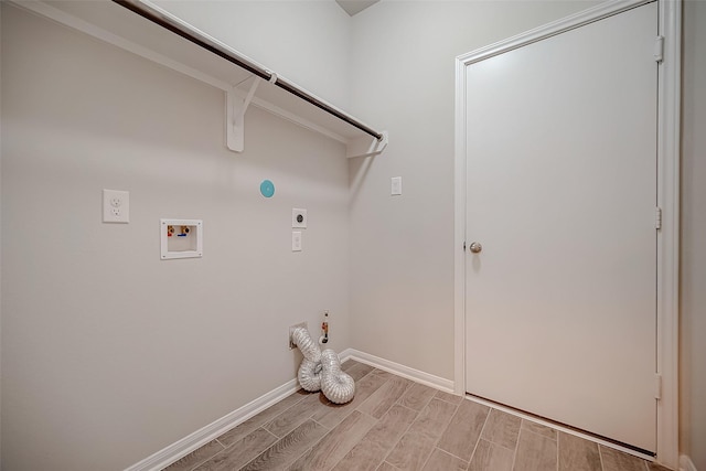 3423 Hackberry Tree Ln, Katy, TX 77449 - clothes washing area featuring hookup for an electric dryer, hookup for a gas dryer, wood finish floors, hookup for a washing machine, and baseboards