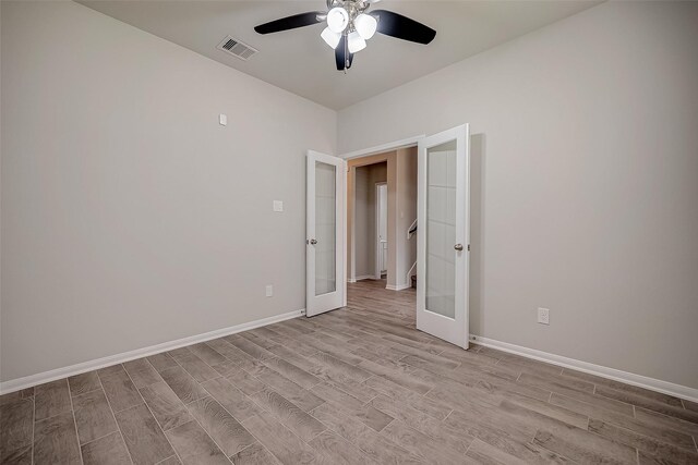3423 Hackberry Tree Ln, Katy, TX 77449 - unfurnished bedroom with light wood-style flooring, french doors, baseboards, and ceiling fan