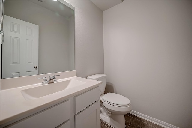 3423 Hackberry Tree Ln, Katy, TX 77449 - half bath with toilet, vanity, baseboards, and wood finished floors