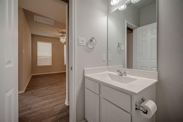 3423 Hackberry Tree Ln, Katy, TX 77449 - bathroom with wood finished floors, vanity, baseboards, and a ceiling fan