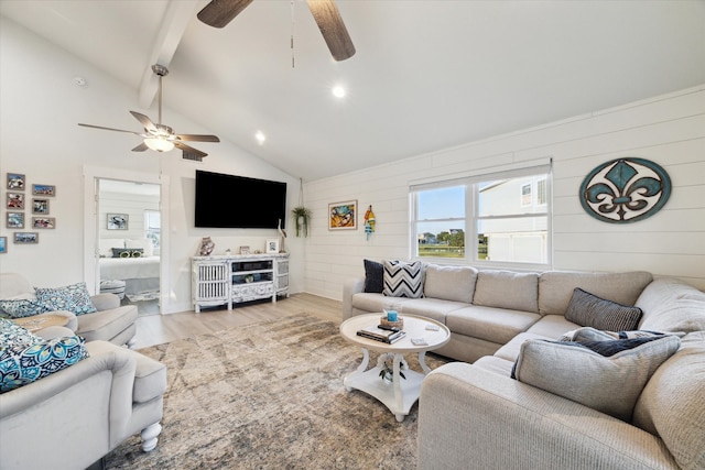 living room featuring ceiling fan, light wood-type flooring, beam ceiling, and high vaulted ceiling