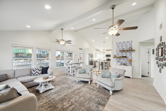 living room with light wood-type flooring, high vaulted ceiling, ceiling fan, and beamed ceiling