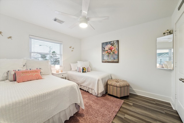 bedroom with dark hardwood / wood-style floors and ceiling fan