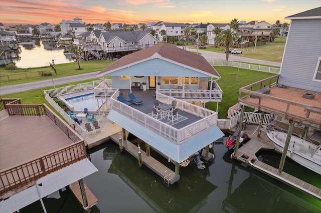 aerial view at dusk with a water view