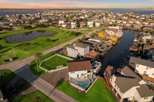 aerial view at dusk with a water view