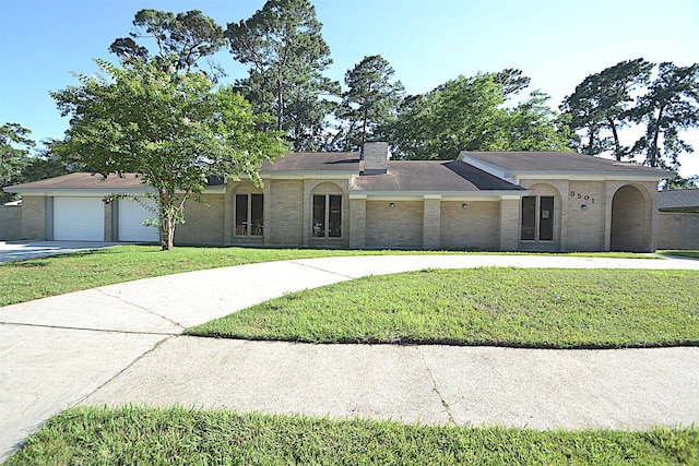 ranch-style house featuring a garage and a front yard