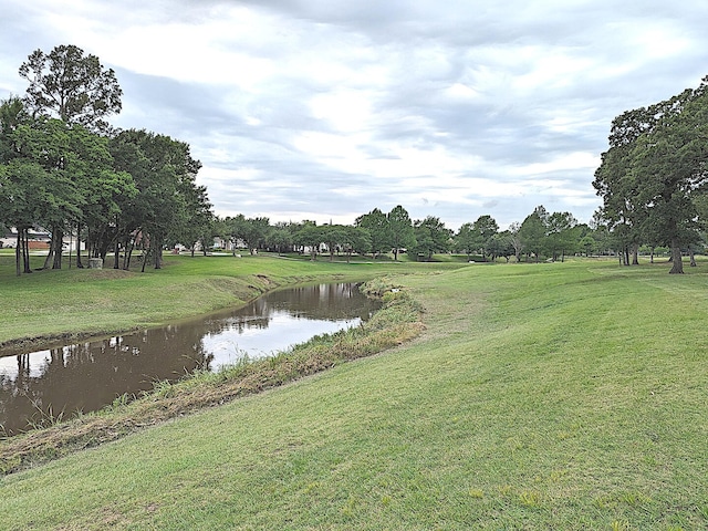 view of community featuring a yard and a water view