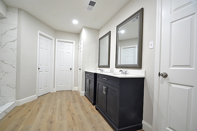 bathroom with hardwood / wood-style floors and vanity