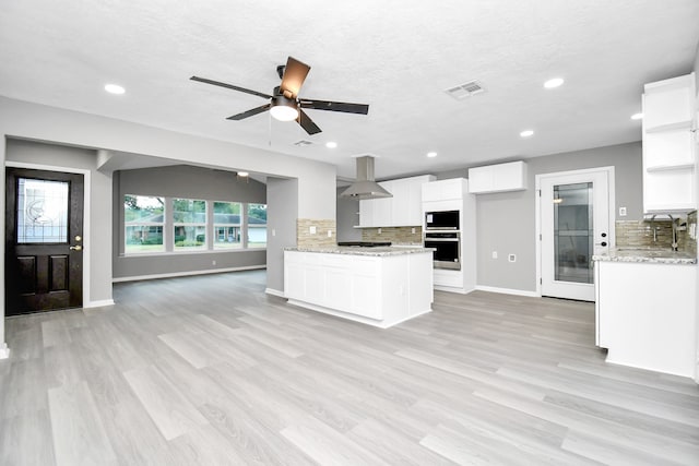 kitchen with tasteful backsplash, sink, light hardwood / wood-style flooring, and white cabinets