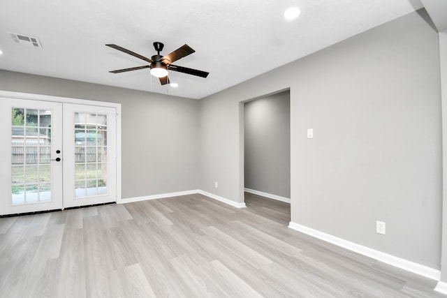 empty room featuring ceiling fan, light hardwood / wood-style flooring, and french doors