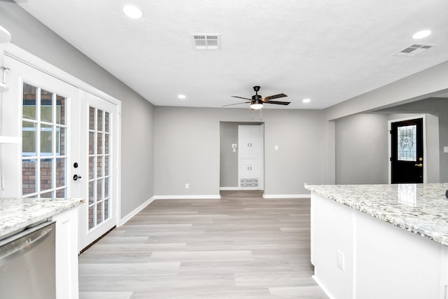 kitchen featuring light wood-type flooring, dishwasher, light stone countertops, ceiling fan, and french doors