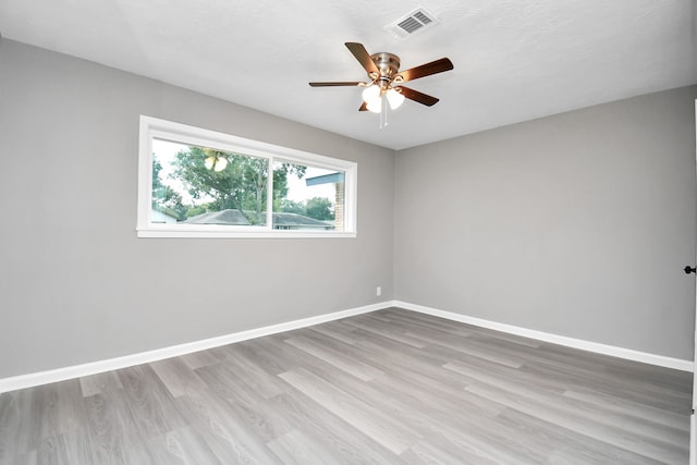 empty room with light wood-type flooring and ceiling fan