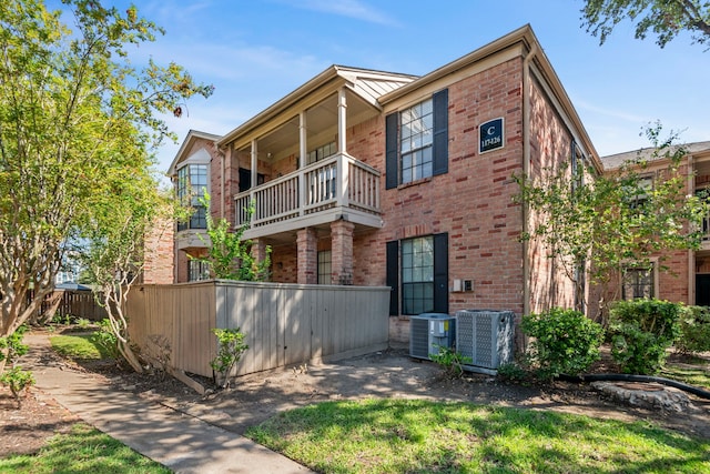 exterior space with central AC unit and a balcony