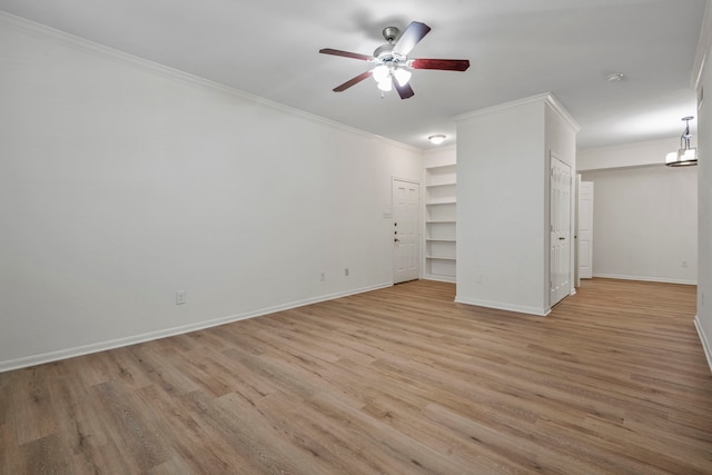 spare room featuring light wood-type flooring, ornamental molding, and ceiling fan