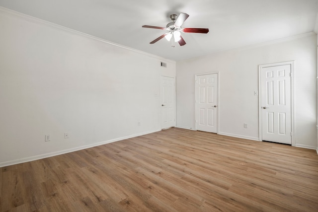 empty room featuring ceiling fan, crown molding, and light hardwood / wood-style floors