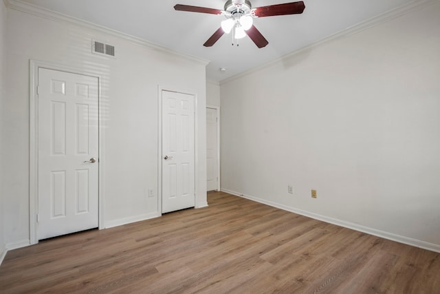 unfurnished bedroom with ceiling fan, crown molding, and light hardwood / wood-style floors