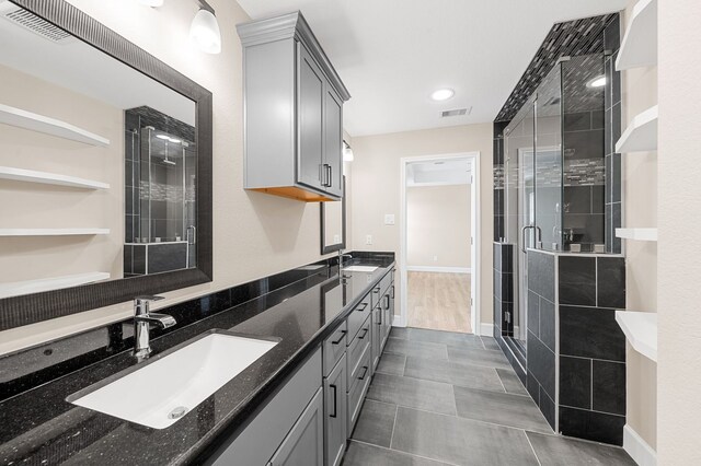 bathroom with vanity, tile patterned floors, and a shower with shower door