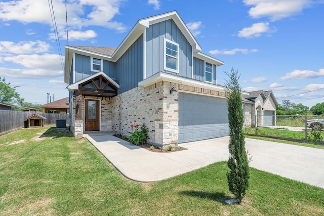 view of front of property featuring cooling unit, a garage, and a front yard