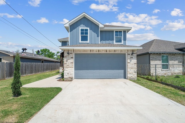 view of front of home featuring a front yard and a garage