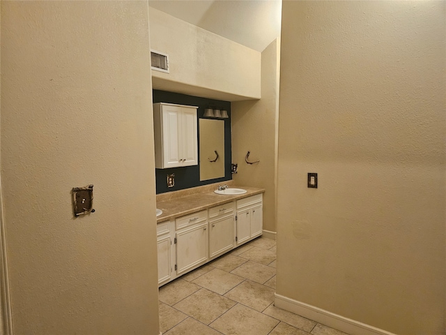 bathroom with tile patterned flooring and vanity