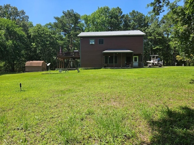 view of yard with a wooden deck and a shed