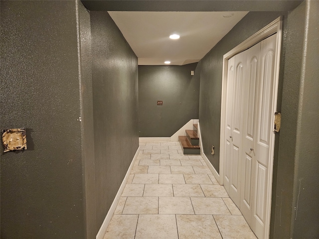 hall featuring light tile patterned flooring