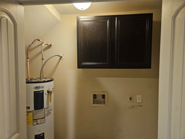 clothes washing area featuring washer hookup, cabinets, and electric water heater