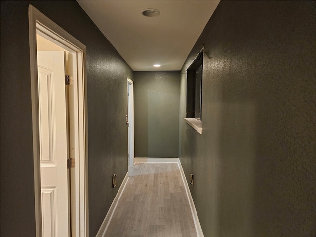 corridor with light hardwood / wood-style flooring