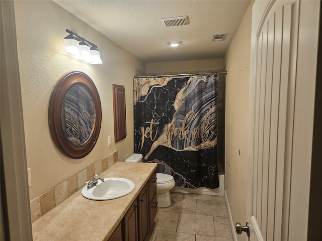 full bathroom with vanity, shower / tub combo with curtain, toilet, and a textured ceiling