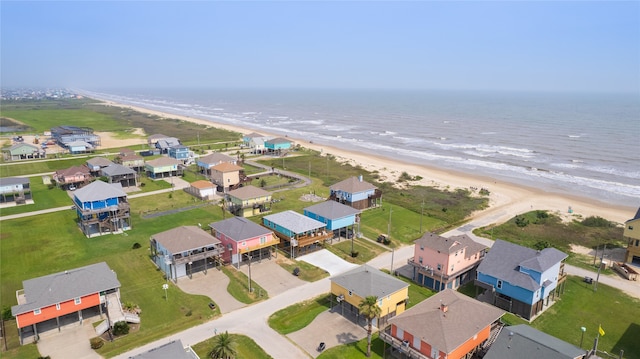 drone / aerial view featuring a water view and a beach view