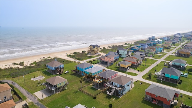 drone / aerial view with a water view and a view of the beach