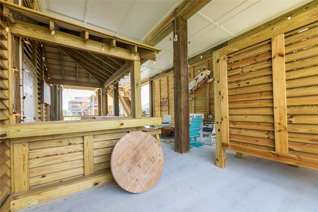 interior space featuring concrete floors and lofted ceiling