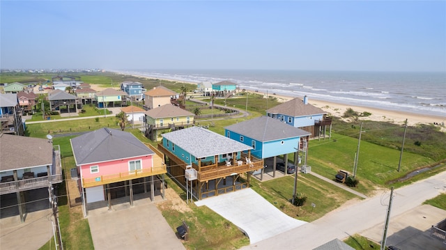 drone / aerial view featuring a beach view and a water view