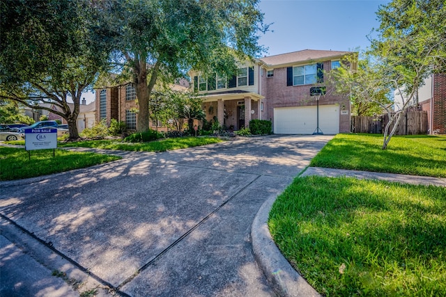 view of front of home with a garage and a front lawn