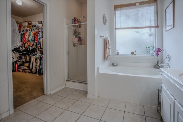 bathroom with vanity, shower with separate bathtub, tile patterned flooring, and a textured ceiling