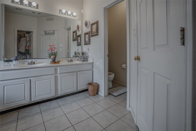 bathroom featuring tile patterned floors, vanity, and toilet