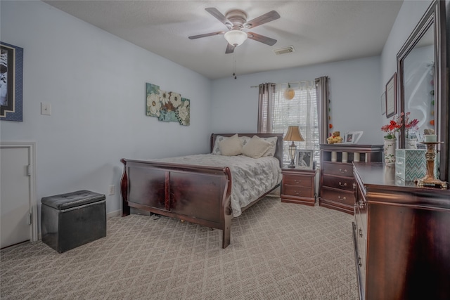 bedroom with ceiling fan and light colored carpet