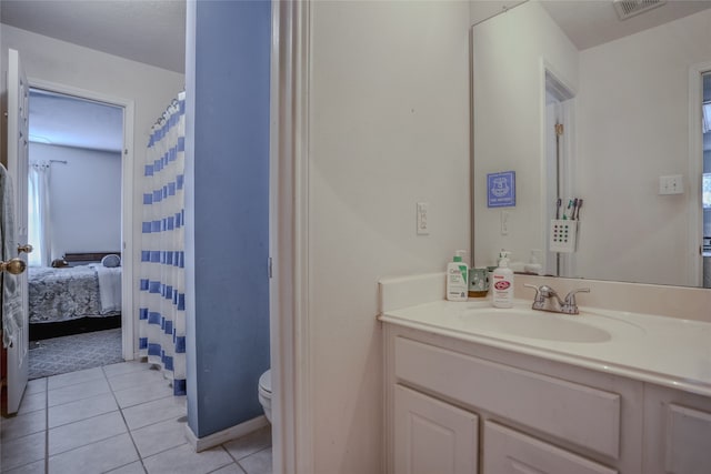 bathroom featuring vanity, toilet, and tile patterned floors