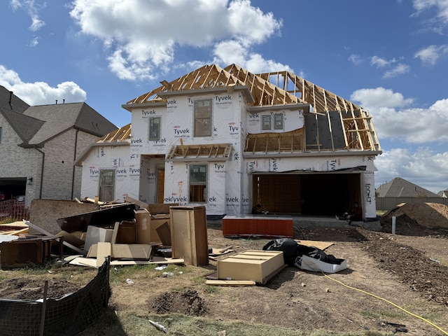 rear view of house with a garage