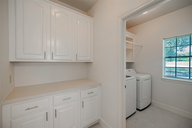 clothes washing area with washing machine and dryer