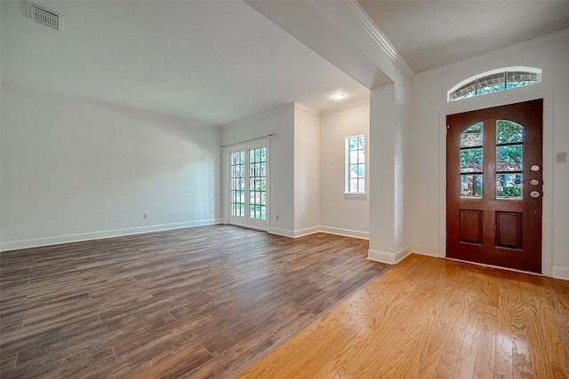 foyer entrance featuring french doors, ornamental molding, and hardwood / wood-style floors