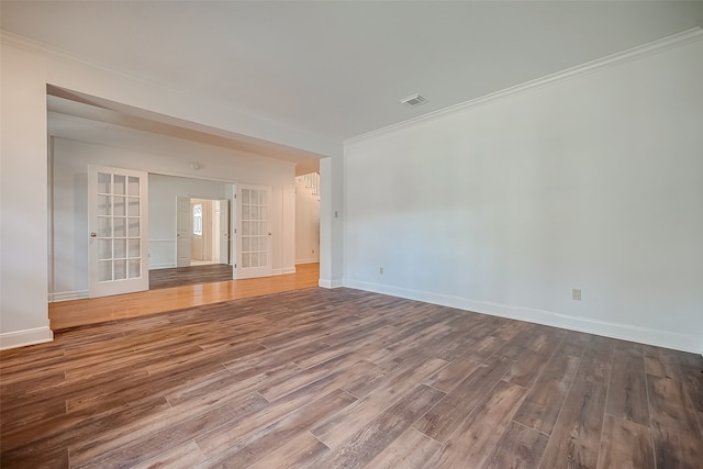 unfurnished room with hardwood / wood-style floors, ornamental molding, and french doors