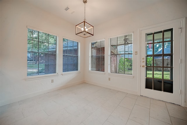 interior space with a wealth of natural light and a chandelier