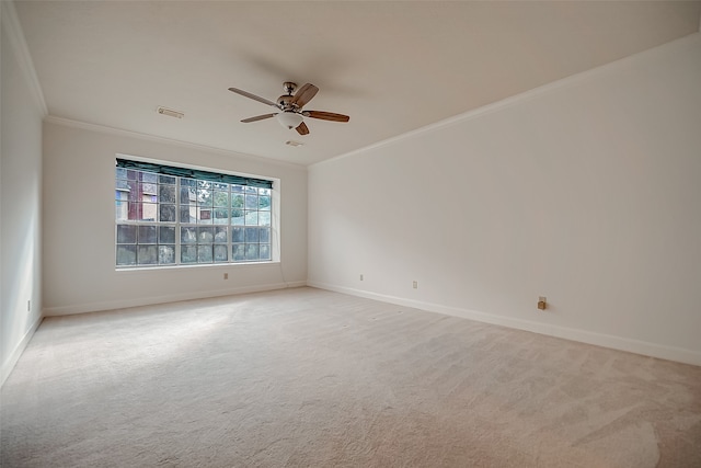 unfurnished room featuring ornamental molding, light carpet, and ceiling fan