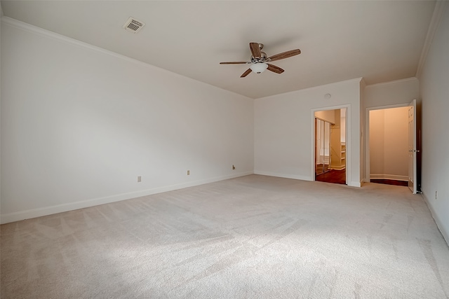 unfurnished bedroom featuring light carpet, crown molding, connected bathroom, and ceiling fan