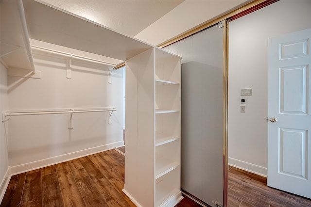 walk in closet featuring dark wood-type flooring