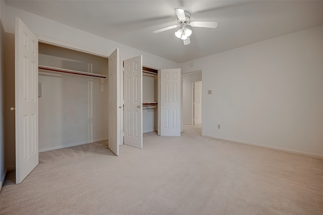 unfurnished bedroom with a closet, ceiling fan, and light carpet